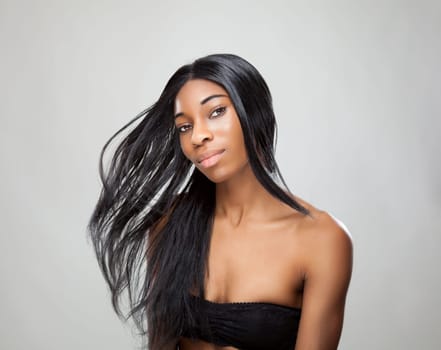 Beautiful young black woman with long straight hair