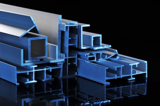 many different aluminium profile strips in blue spotlight