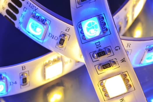 Macrodetail of an RGB LED strip combined with warm white LEDs in colored light