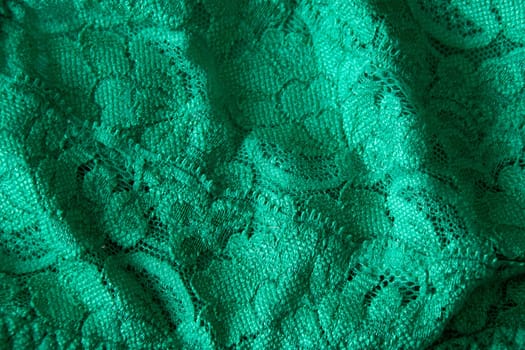 Close up image of green lace material filling the image.