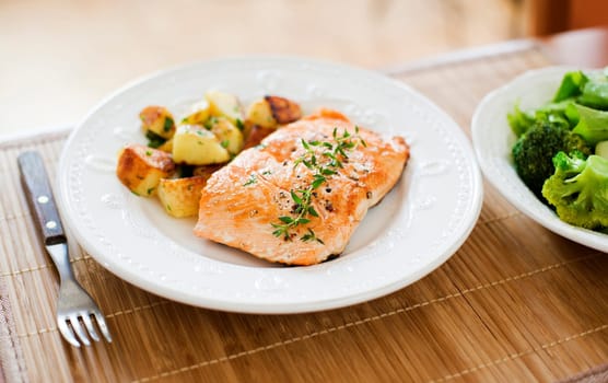 Fresh salmon steak with potato and salad