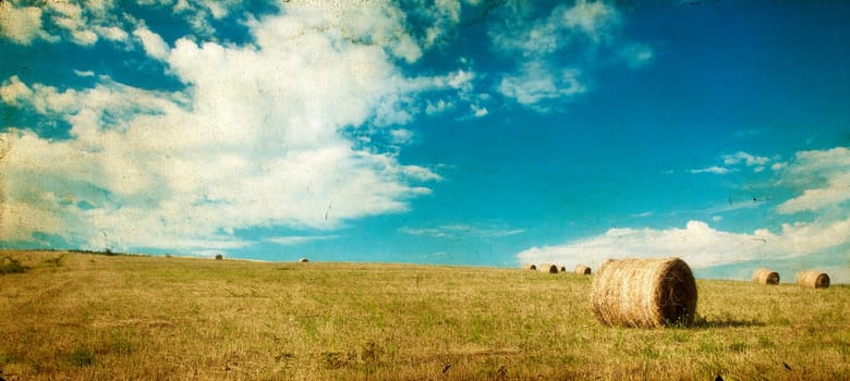 Vintage photo of hay-roll on field after harvest