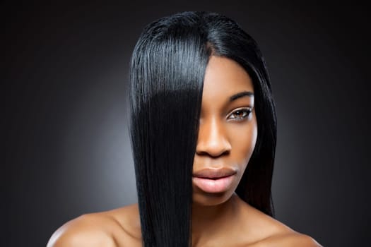 Beautiful young black woman with straight shiny hair