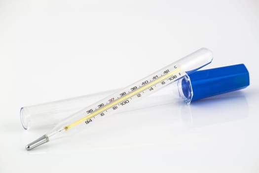 Glass mercury thermometer isolated on white background