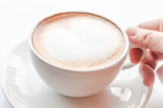 Hand on cup of hot coffee latte