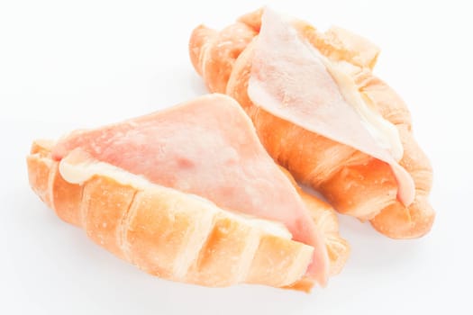 Couple of mini ham cheese croissants isolated on white background