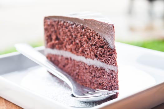 Chocolate custard cake serving with spoon and fork