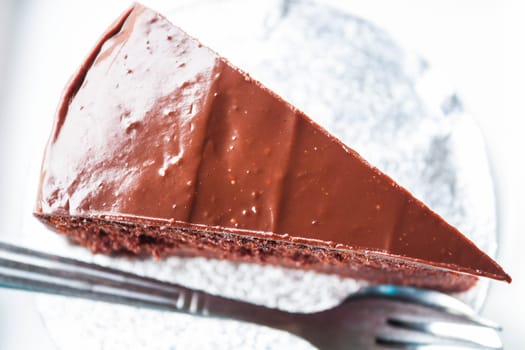 Top view of chocolate cake with spoon and fork