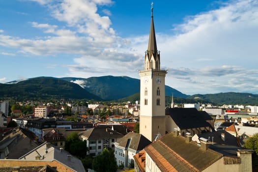 Aerial view over the town center and the largest church of Villach in Carinthia/Austria on a sunny day. Villach belongs to the largest cities of Austria and is nicely surrounded by several mountains.