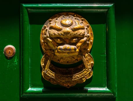 An old knocker at the door of a house in Valletta as typical for Malta