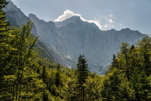 View to Mt. Triglav, the highest mountain and national symbol of Slovenia, from the mountain hut Aljazev Dom. The mountains of the Julian Alps form an impressive wall in that view.