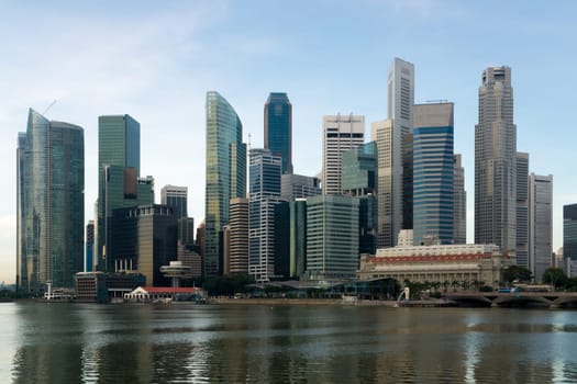 Morning view of the impressive skyline of Singapore's central business district as seen from the Esplanade over the Marina Bay.