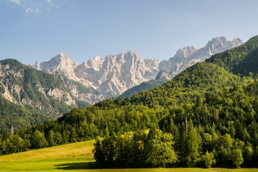 View to the Julian Alps inclduing Mt. Triglav, the highest mountain and national symbol of Slovenia, from the Kranjska Gora region. The mountains of the Julian Alps form an impressive wall in that view.