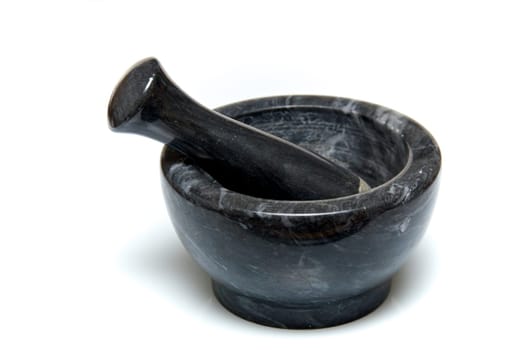 A traditional marble mortar and pestle used for grinding up herbs or drugs, usually used for cooking or by apothecaries, shot on white background.