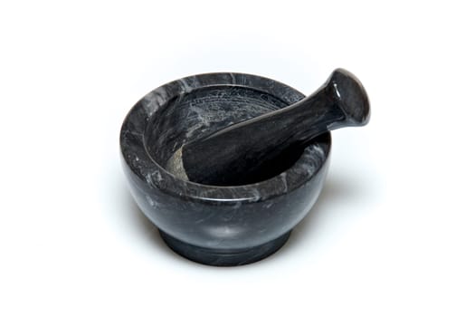 A traditional marble mortar and pestle used for grinding up herbs or drugs, usually used for cooking or by apothecaries, shot on white background.