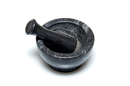 A traditional marble mortar and pestle used for grinding up herbs or drugs, usually used for cooking or by apothecaries, shot on white background.