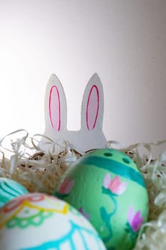 Easter eggs , flowers and funny bunny to celebrate Easter. space for copy.Wallpaper for Easter announcements and cards.Vertical real picture, ideal for social media stories and postings