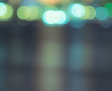 Blurred bokeh city lights with reflection on water