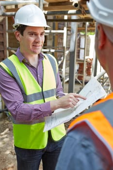 Architect Discussing Plans With Builder