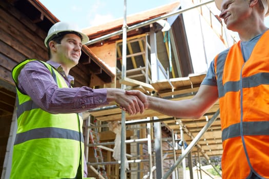 Architect Shaking Hands With With Builder