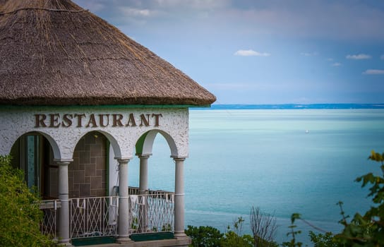 An ancient built thatched roof restaurant in front of the lake Balaton.
