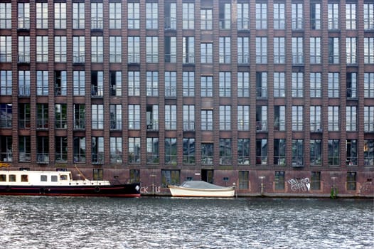 The photograph of an old brick building with offices on the Spree in Berlin.