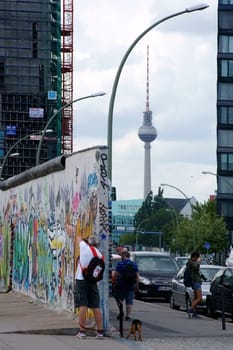 Berlin,Germany -June 16,2014: Tourists photograph a piece of the Berlin Wall at the East Side Gallery on June 16,2014 in Berlin.