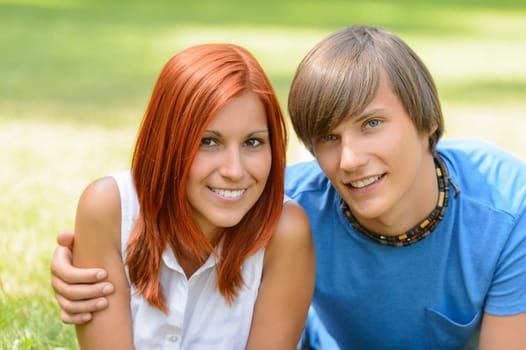 Teenage couple hugging enjoy summer day looking at camera