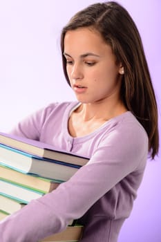 Desperate student girl carry stack of books purple background