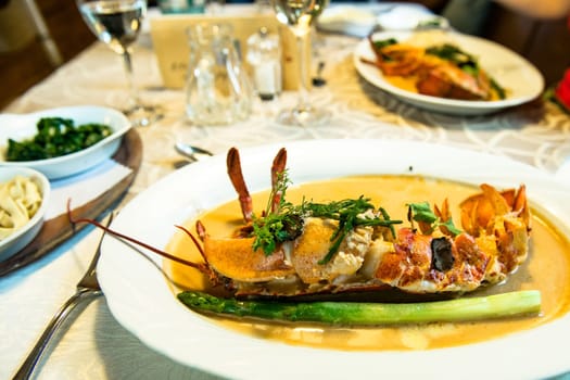 Lobster with lobster sauce and asparagus in a restaurant