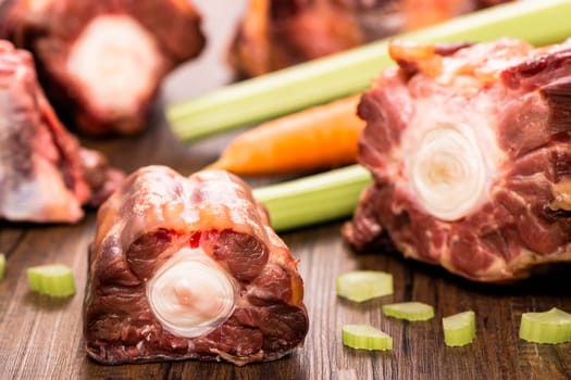 Raw piece of meat from oxtail with celery