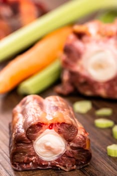 Oxtail raw with vegetables in portrait format