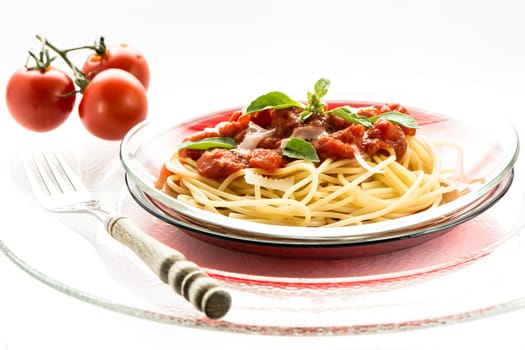Spaghetti with tomato sauce on a plate of glass