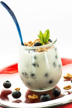 Yoghurt with heather berries,mint and cantucinni in a glass