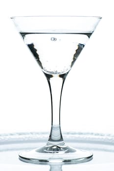 Glass with gin tonic and carbonic acid in the backlight
