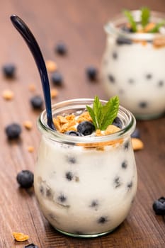 Glass of yoghurt with blueberries,mint and cantuccini