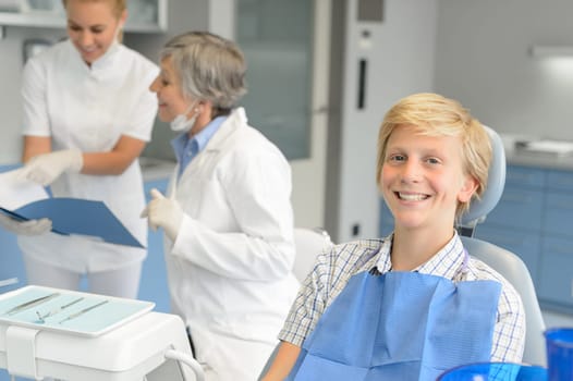 Dental checkup teenage patient boy and dentist nurse at stomatology clinic