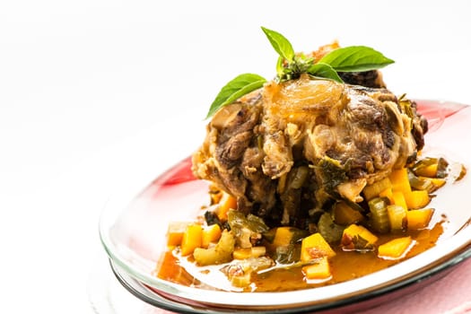 Plate with braised oxtail and carrots and celery