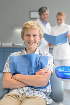 Teenager boy dental checkup dentist assistant standing at stomatology clinic