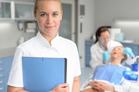 Dental assistant dentist checkup woman patient at stomatology clinic