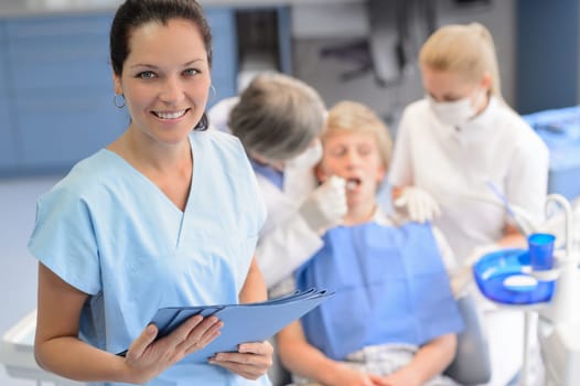 Professional dentist  team checkup teenage patient boy at dental surgery