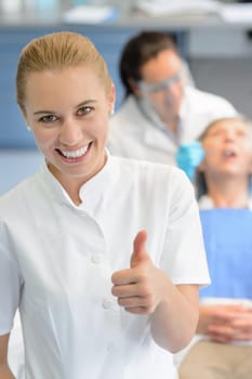 Dental assistant dentist checkup patient woman at professional clinic thumbup