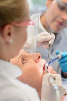 Professional dental team dentist checkup patient woman open mouth tools