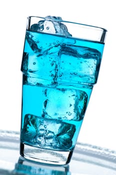 Glass with blue drink with ice cubein the backlight