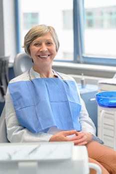 Elderly woman patient sitting chair at dental surgery teeth checkup