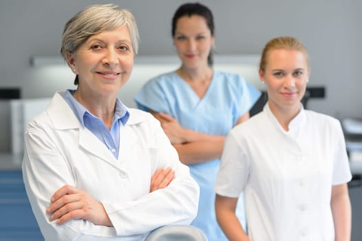 Medical team of three professional woman at dental surgery portrait