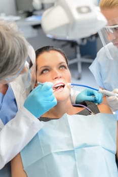 Dental team checkup woman patient teeth open mouth stomatology clinic