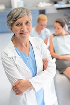 Professional dentist surgeon woman assistant with patient at dental clinic