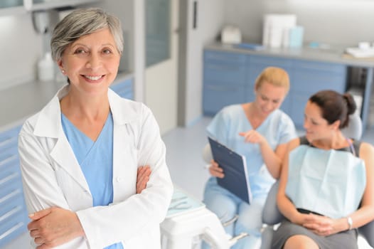 Professional dentist woman patient consultation with assistant at dental surgery