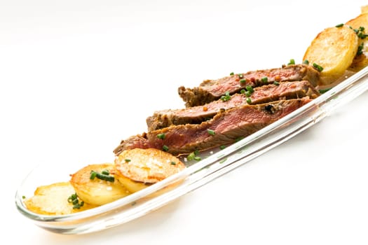 Roasted strip of entrecote with roast potatoes and chigs